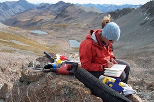 Samples of glacial debris, like this boulder, lets researchers retrace the path of ancient glaciers. Credit: Mike Kaplan. (Alice Doughty, University of Maine pictured)